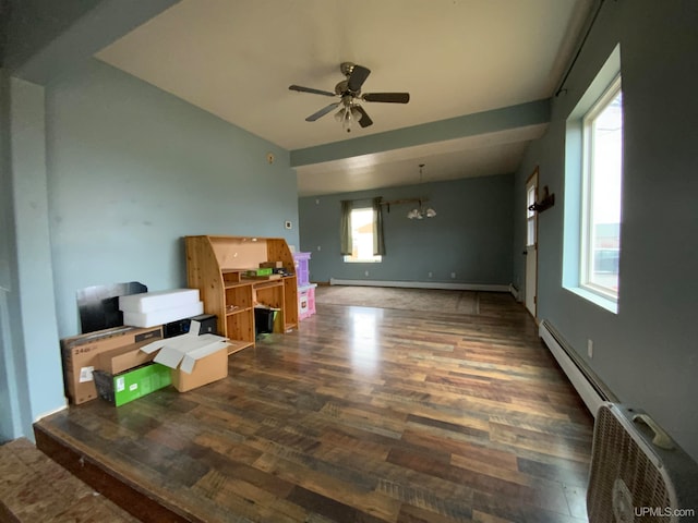 interior space with dark hardwood / wood-style floors, ceiling fan with notable chandelier, and a baseboard radiator