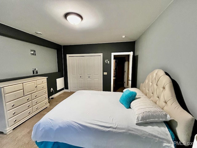 bedroom with light carpet and a closet