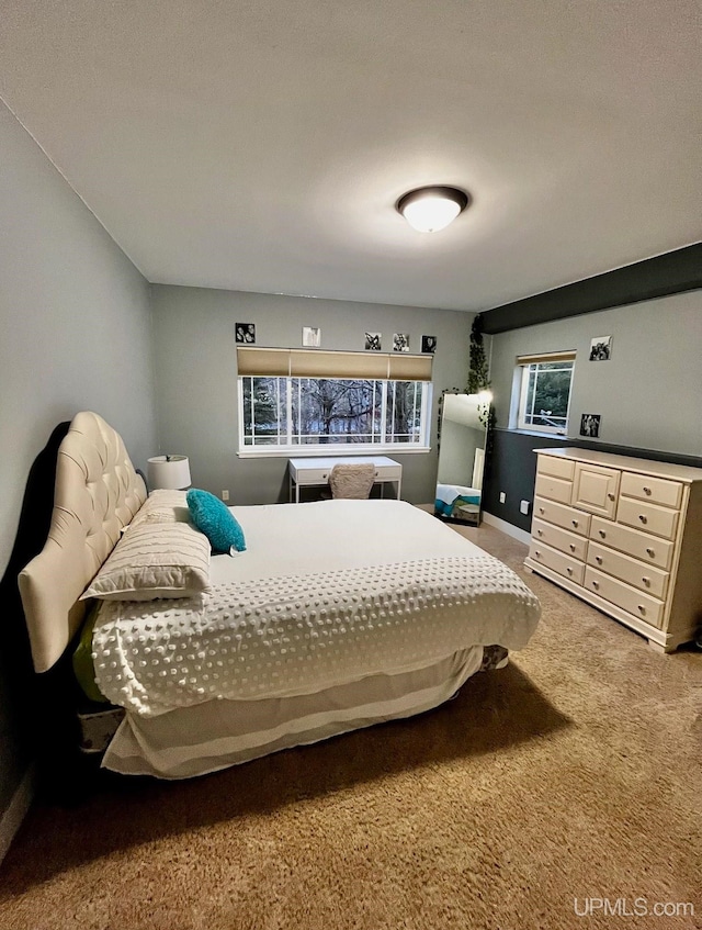 carpeted bedroom featuring multiple windows