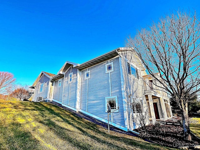 view of side of home featuring a yard