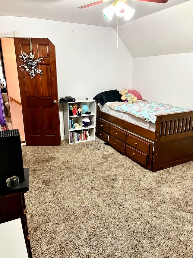 carpeted bedroom with vaulted ceiling and ceiling fan