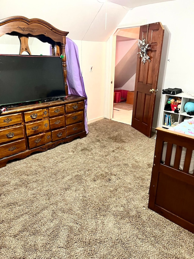 carpeted bedroom featuring vaulted ceiling