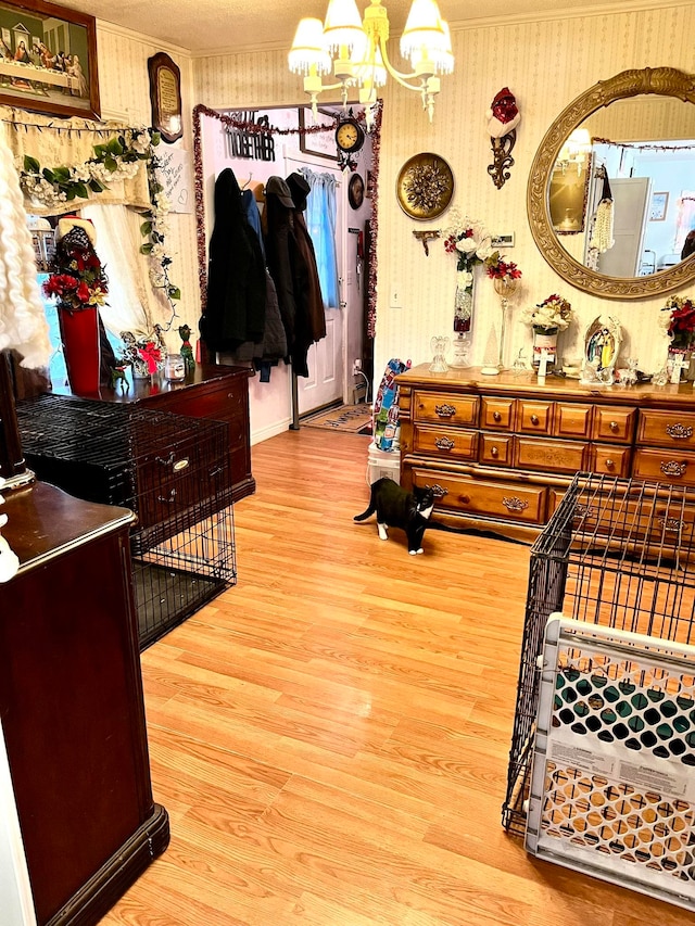 bedroom featuring hardwood / wood-style flooring, ornamental molding, and a chandelier