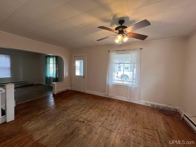 interior space with plenty of natural light, dark hardwood / wood-style floors, baseboard heating, and ceiling fan