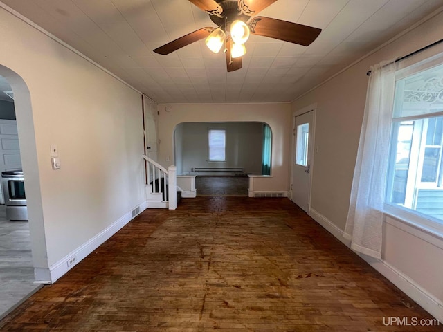 corridor featuring dark hardwood / wood-style flooring, crown molding, and a baseboard radiator