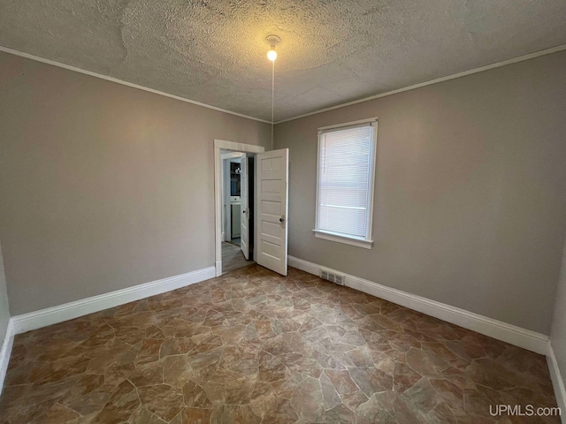 interior space with a textured ceiling and ornamental molding