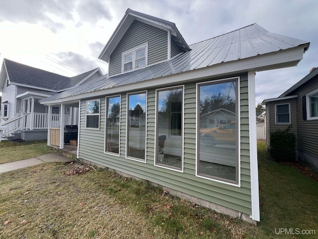 rear view of property featuring a yard