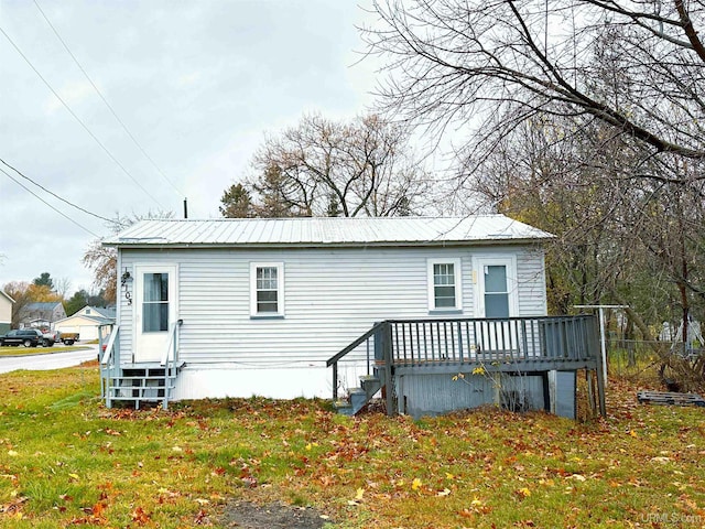 back of house with a yard and a wooden deck