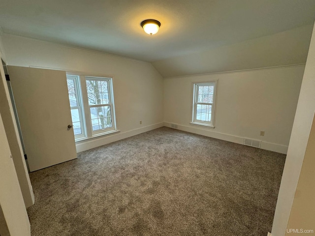 unfurnished room with carpet floors and lofted ceiling