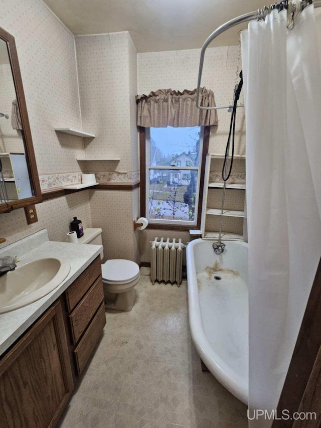 full bathroom featuring shower / bath combo, vanity, toilet, and radiator