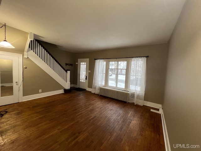 unfurnished living room with radiator and dark hardwood / wood-style floors