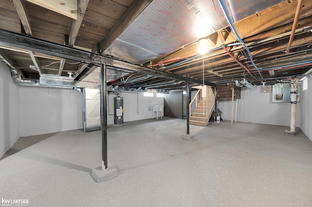 basement featuring gas water heater and sink