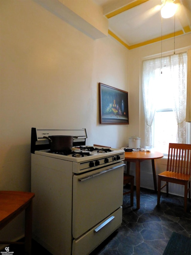 kitchen featuring white range with gas stovetop