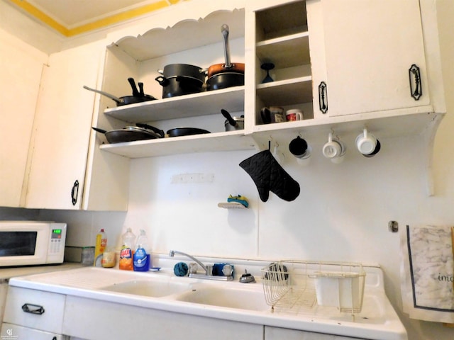 kitchen featuring white cabinets and sink