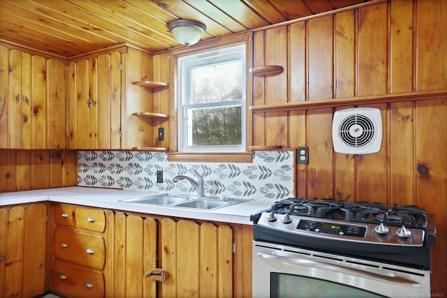 kitchen with decorative backsplash, stainless steel gas stove, wood ceiling, and sink