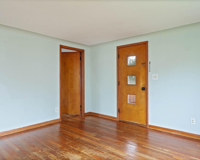 unfurnished room featuring hardwood / wood-style floors