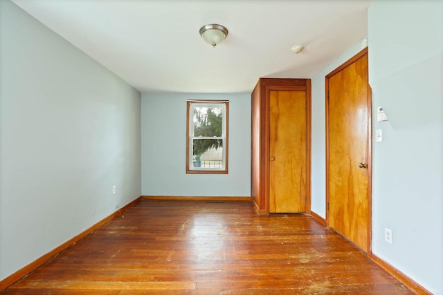 spare room featuring wood-type flooring