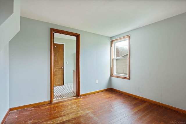 spare room featuring wood-type flooring