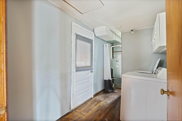 washroom with dark hardwood / wood-style flooring, cabinets, and washing machine and clothes dryer