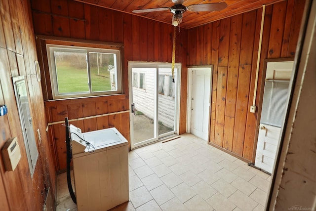 entryway with ceiling fan, wooden ceiling, and wooden walls