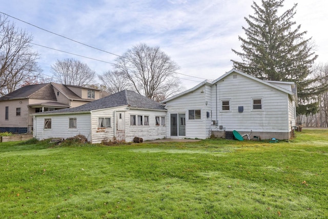 310 S Main St, Vassar, MI 48768 - back of property with a lawn and a shingled roof