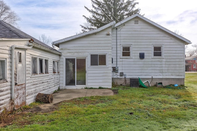 310 S Main St, Vassar, MI 48768 - rear view of property featuring a yard, a patio, and central AC
