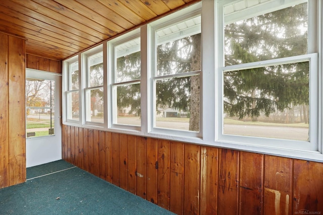 unfurnished sunroom with wood ceiling