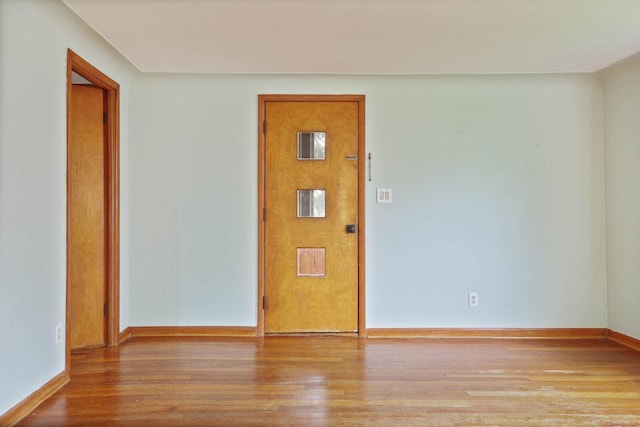 unfurnished room featuring hardwood / wood-style flooring