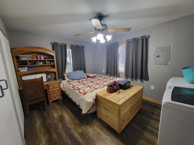 bedroom with multiple windows, ceiling fan, dark hardwood / wood-style floors, and washer / dryer