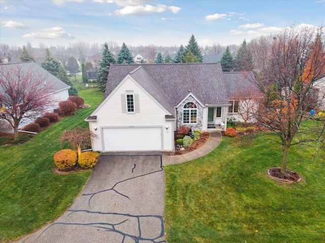 view of front of house with a garage and a front yard