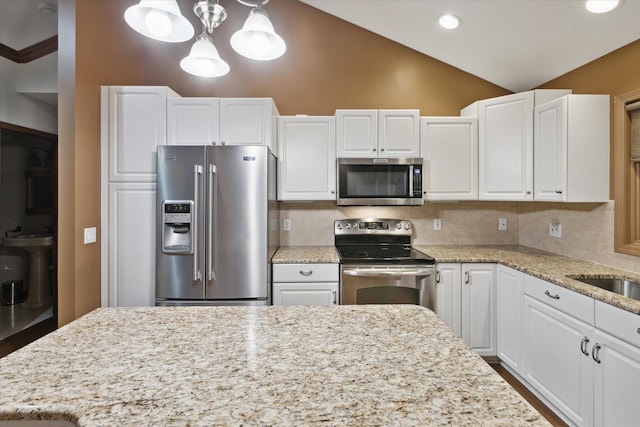 kitchen with white cabinets, hanging light fixtures, backsplash, and appliances with stainless steel finishes