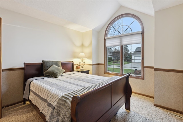 bedroom with carpet and vaulted ceiling