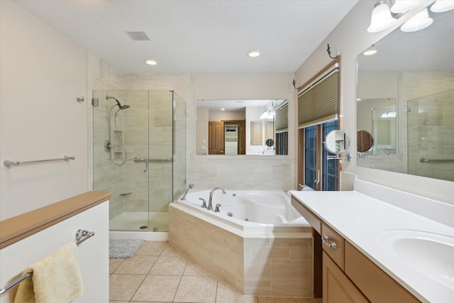 bathroom featuring tile patterned floors, vanity, and plus walk in shower