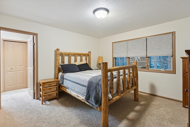 carpeted bedroom featuring a textured ceiling