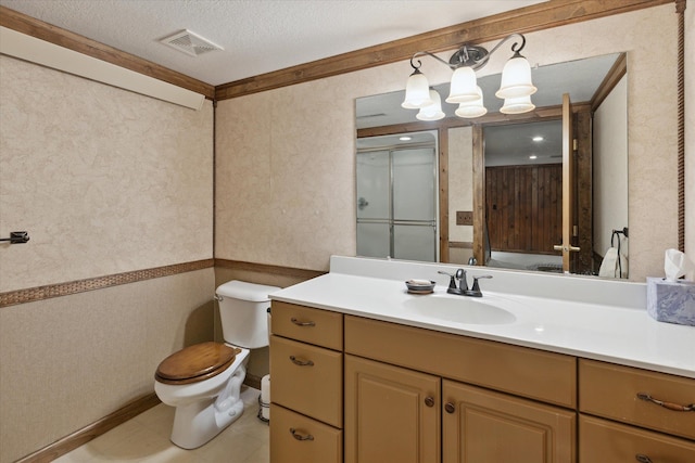 bathroom with vanity, crown molding, tile patterned flooring, toilet, and a textured ceiling