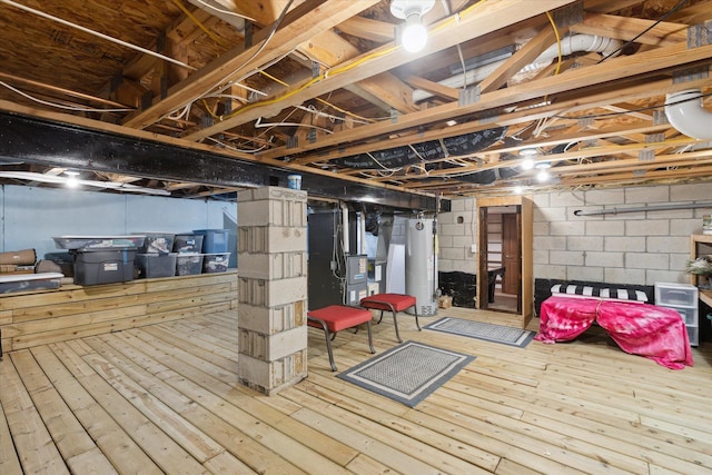 basement with heating unit, water heater, and wood-type flooring