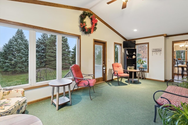 interior space featuring carpet, ceiling fan with notable chandelier, vaulted ceiling, and ornamental molding