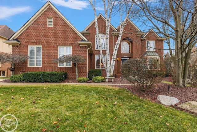 view of front of house featuring brick siding and a front lawn