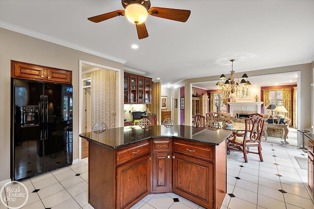 kitchen with glass insert cabinets, ornamental molding, black refrigerator with ice dispenser, and a center island