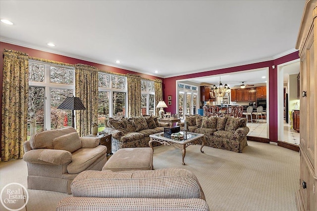 living area featuring recessed lighting, ceiling fan with notable chandelier, crown molding, and light colored carpet