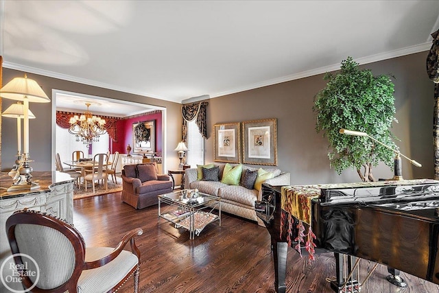 living room with a chandelier, ornamental molding, and wood finished floors