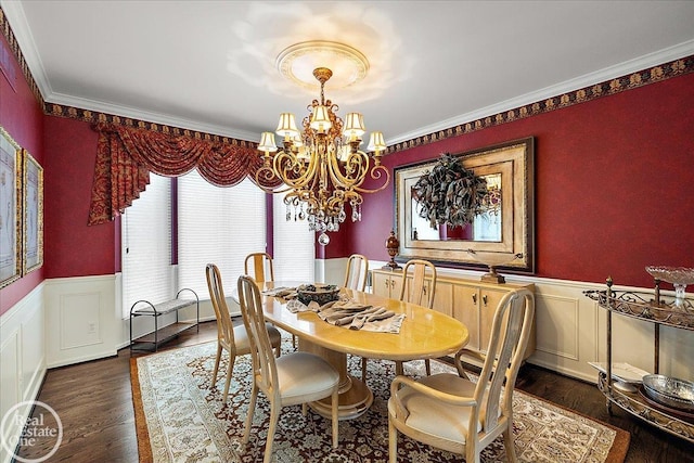 dining room featuring ornamental molding, dark wood-style flooring, wainscoting, and a notable chandelier