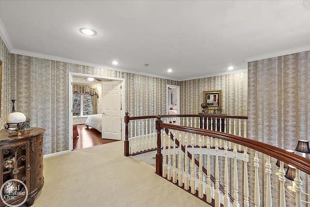 hallway with carpet floors, crown molding, recessed lighting, an upstairs landing, and wallpapered walls