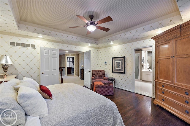 bedroom with dark wood finished floors, crown molding, visible vents, baseboards, and wallpapered walls