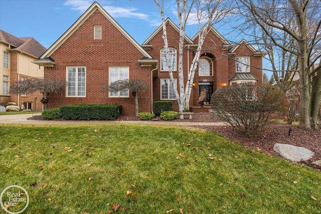 traditional-style house featuring a front lawn and brick siding