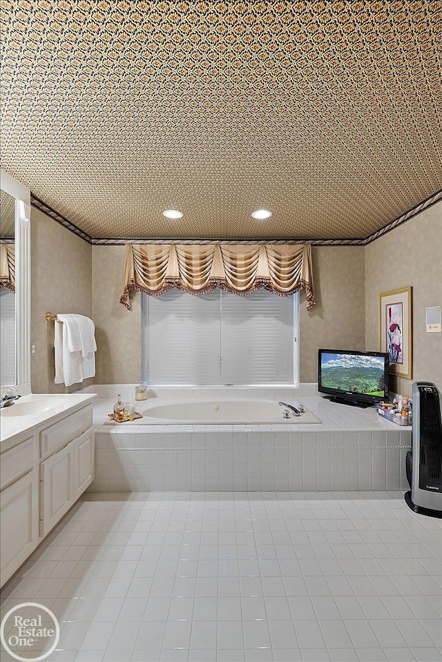 bathroom with tile patterned flooring, vanity, and a bath