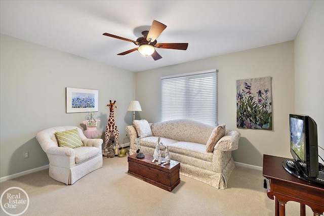 carpeted living area featuring baseboards and a ceiling fan