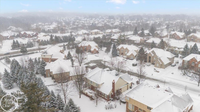 snowy aerial view featuring a residential view