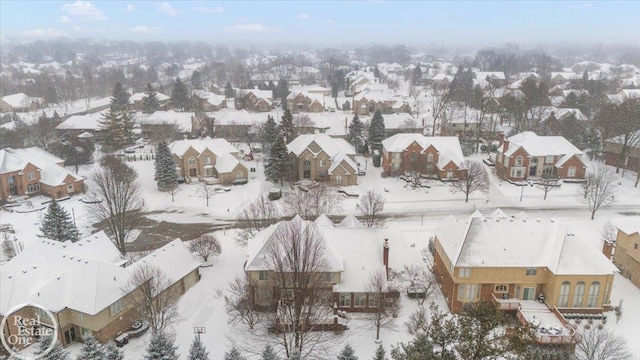 snowy aerial view with a residential view