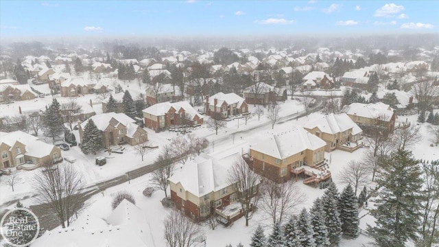 snowy aerial view featuring a residential view